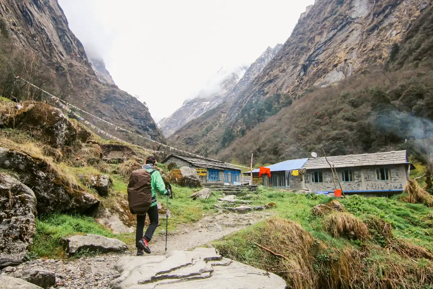 A photo of pilgrims trekking towards Kedarnath yatra, with beautiful mountain scenery in the background.